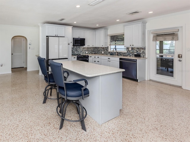 kitchen with dishwasher, black electric range oven, ornamental molding, light countertops, and plenty of natural light