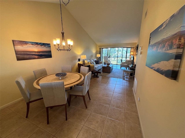 1154 Bird Bay Way Unit 303, Venice, FL 34285 - tiled dining area with a chandelier, high vaulted ceiling, and baseboards