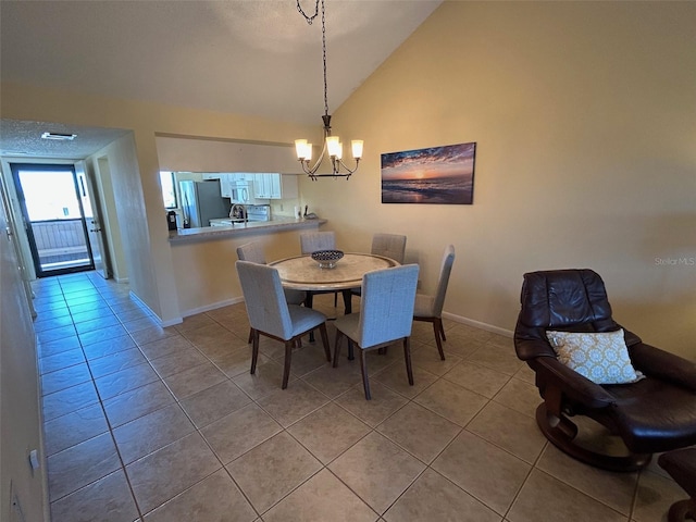 1154 Bird Bay Way Unit 303, Venice, FL 34285 - dining area featuring a chandelier, light tile patterned floors, baseboards, and high vaulted ceiling
