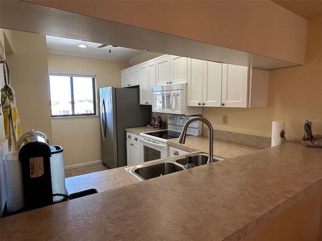 1154 Bird Bay Way Unit 303, Venice, FL 34285 - kitchen featuring white appliances, a sink, white cabinets, a ceiling fan, and light countertops