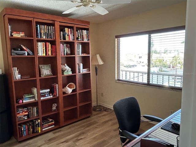 1154 Bird Bay Way Unit 303, Venice, FL 34285 - office space featuring a ceiling fan, wood finished floors, and a textured ceiling