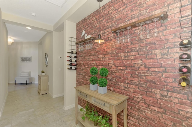 241 Marcheno Way, Nokomis, FL 34275 - hallway featuring brick wall and baseboards