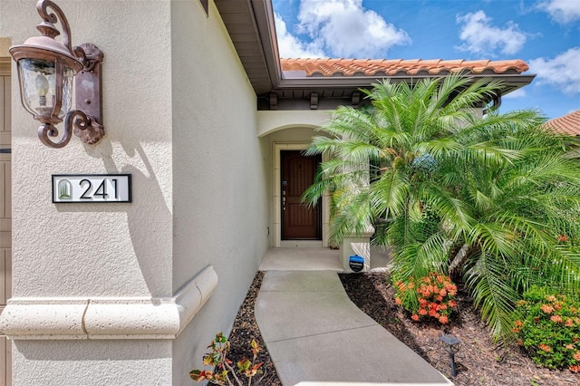 241 Marcheno Way, Nokomis, FL 34275 - view of exterior entry featuring stucco siding and a tile roof