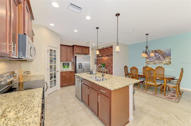 241 Marcheno Way, Nokomis, FL 34275 - kitchen featuring stainless steel appliances, a sink, tasteful backsplash, an island with sink, and light stone counters