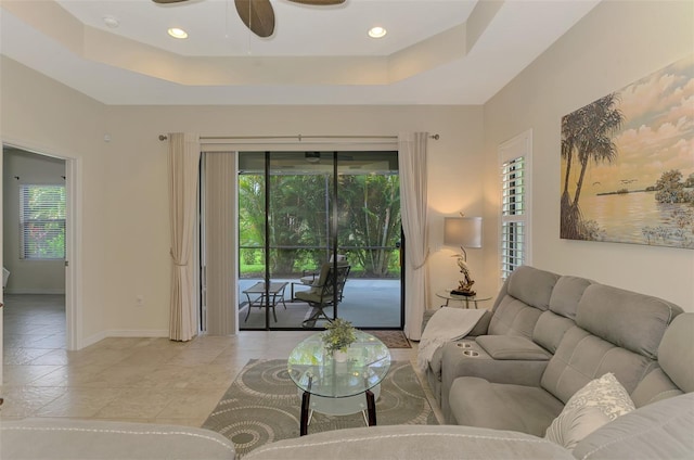 241 Marcheno Way, Nokomis, FL 34275 - living area with a ceiling fan, healthy amount of natural light, a tray ceiling, and light tile patterned floors