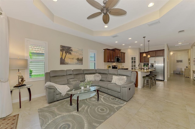 241 Marcheno Way, Nokomis, FL 34275 - living area with a ceiling fan, a raised ceiling, recessed lighting, and baseboards