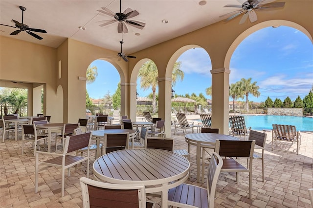 241 Marcheno Way, Nokomis, FL 34275 - view of patio / terrace featuring outdoor dining area, ceiling fan, and a community pool