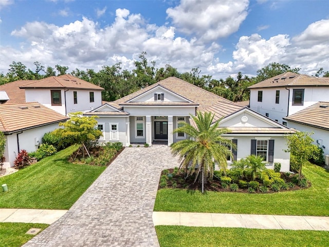 9048 Luna Ln, Sarasota, FL 34241 - view of front of home featuring a front yard, driveway, and stucco siding