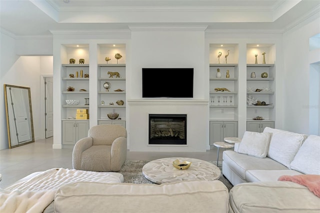 9048 Luna Ln, Sarasota, FL 34241 - living room with built in features, a glass covered fireplace, crown molding, a raised ceiling, and light tile patterned floors
