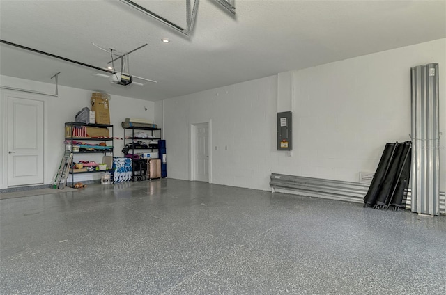 9048 Luna Ln, Sarasota, FL 34241 - garage with electric panel, a garage door opener, and concrete block wall
