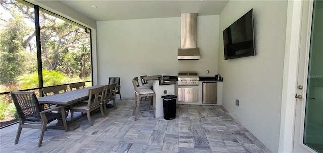 9048 Luna Ln, Sarasota, FL 34241 - kitchen featuring plenty of natural light, wall chimney exhaust hood, and dark countertops
