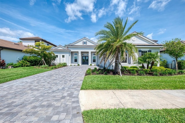 9048 Luna Ln, Sarasota, FL 34241 - view of front of property with decorative driveway, a front lawn, stucco siding, and a porch