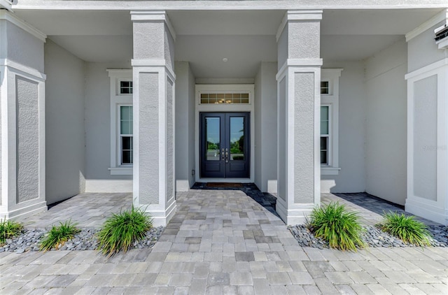9048 Luna Ln, Sarasota, FL 34241 - property entrance featuring french doors and stucco siding