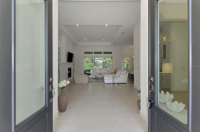 9048 Luna Ln, Sarasota, FL 34241 - entrance foyer featuring a raised ceiling, tile patterned flooring, recessed lighting, and a glass covered fireplace
