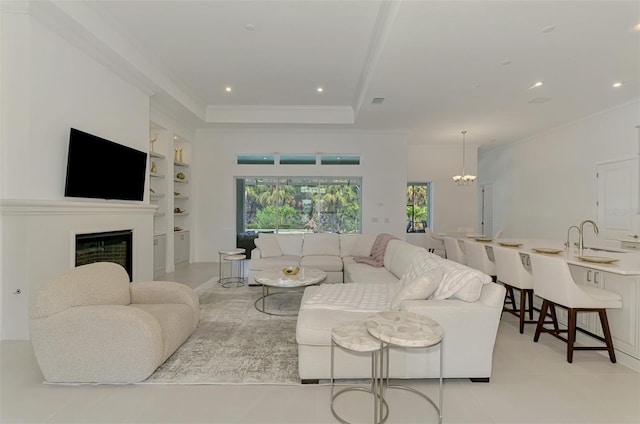 9048 Luna Ln, Sarasota, FL 34241 - living area featuring built in shelves, ornamental molding, a fireplace, a chandelier, and recessed lighting