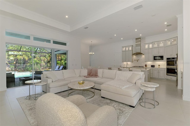 9048 Luna Ln, Sarasota, FL 34241 - living area featuring light tile patterned flooring, crown molding, recessed lighting, and a chandelier