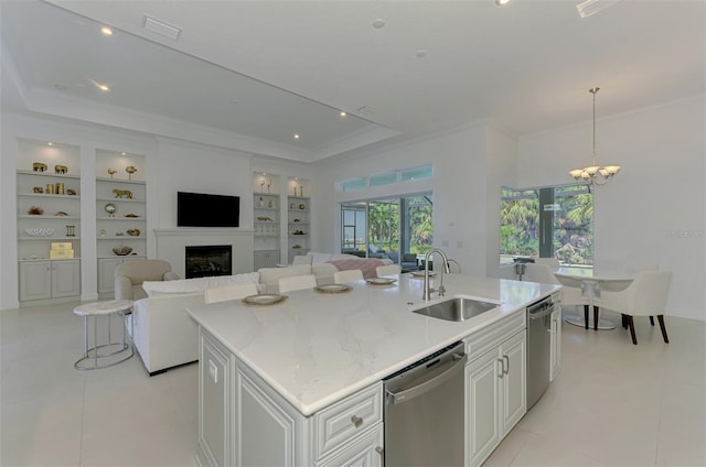 9048 Luna Ln, Sarasota, FL 34241 - kitchen featuring a sink, stainless steel dishwasher, built in features, a tray ceiling, and ornamental molding