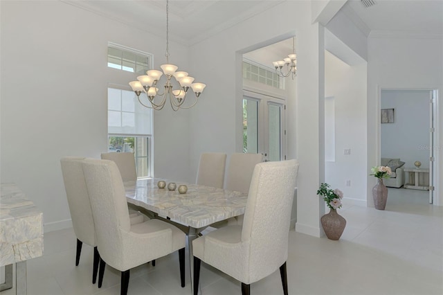 9048 Luna Ln, Sarasota, FL 34241 - dining area featuring a chandelier, crown molding, healthy amount of natural light, a towering ceiling, and baseboards