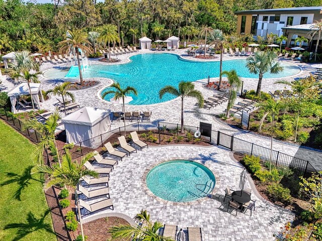9048 Luna Ln, Sarasota, FL 34241 - community pool with a patio and view of wooded area