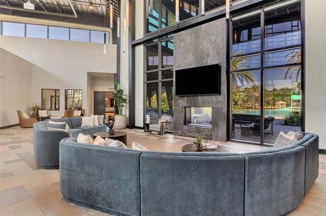 9048 Luna Ln, Sarasota, FL 34241 - living area featuring a towering ceiling, a fireplace, and baseboards