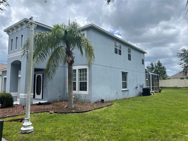 5966 Willows Bridge Loop, Ellenton, FL 34222 - view of property exterior featuring stucco siding, a yard, and glass enclosure