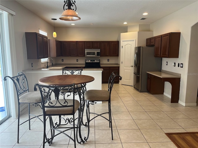 5966 Willows Bridge Loop, Ellenton, FL 34222 - kitchen with appliances with stainless steel finishes, light countertops, light tile patterned floors, and recessed lighting