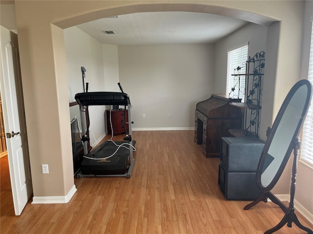5966 Willows Bridge Loop, Ellenton, FL 34222 - exercise room featuring arched walkways and light wood-style floors