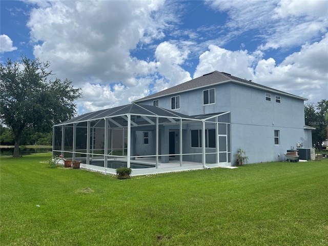 5966 Willows Bridge Loop, Ellenton, FL 34222 - back of house with a lawn, stucco siding, a patio, and glass enclosure
