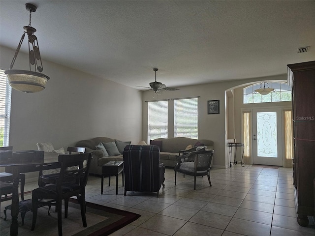 5966 Willows Bridge Loop, Ellenton, FL 34222 - dining area with arched walkways, tile patterned floors, a ceiling fan, and a textured ceiling