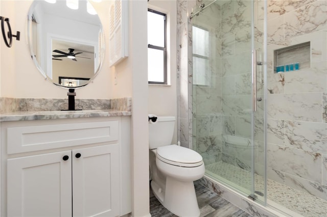 1439 Strada D Argento, Venice, FL 34292 - bathroom with a shower stall, toilet, ceiling fan, and vanity