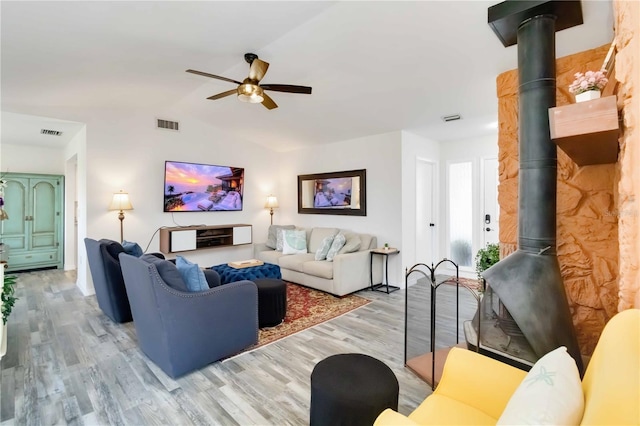 1439 Strada D Argento, Venice, FL 34292 - living area with a wood stove, light wood-type flooring, ceiling fan, and vaulted ceiling