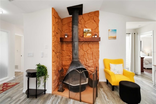 1439 Strada D Argento, Venice, FL 34292 - sitting room with a wood stove, wood finished floors, and vaulted ceiling