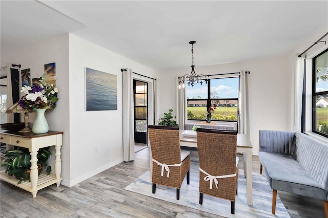 1439 Strada D Argento, Venice, FL 34292 - dining area featuring a chandelier, light wood finished floors, and healthy amount of natural light
