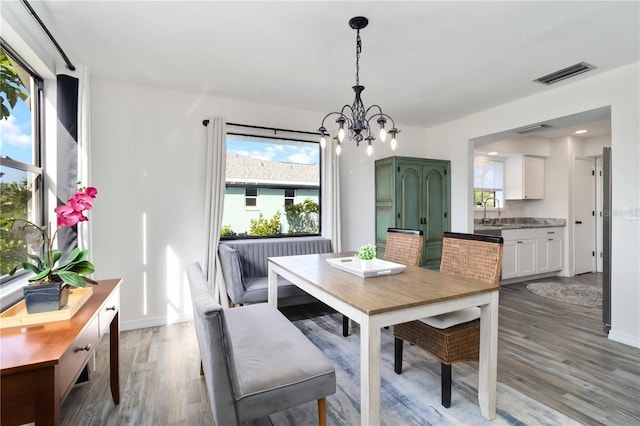 1439 Strada D Argento, Venice, FL 34292 - dining room featuring a chandelier and light wood-style flooring