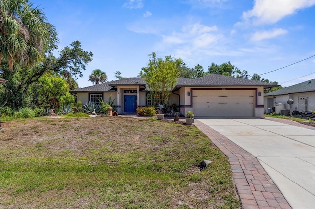 2424 Affinity Ln, North Port, FL 34286 - single story home with a garage, stucco siding, driveway, a front lawn, and cooling unit
