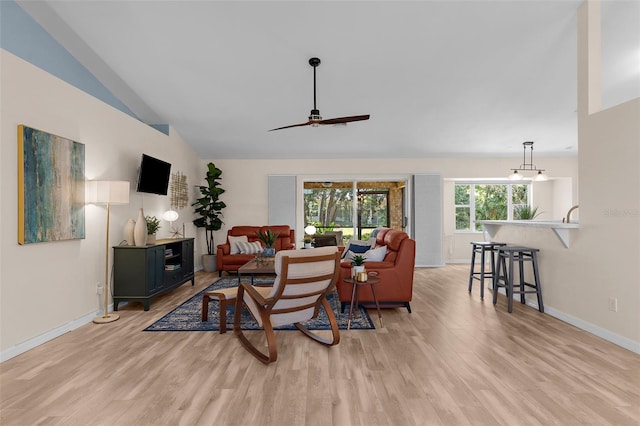 2424 Affinity Ln, North Port, FL 34286 - living room featuring light wood-type flooring, a ceiling fan, lofted ceiling, and baseboards