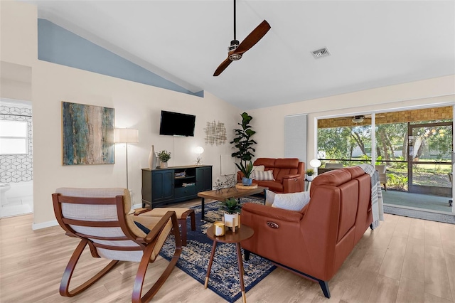 2424 Affinity Ln, North Port, FL 34286 - living area with a ceiling fan, lofted ceiling, light wood-type flooring, and plenty of natural light