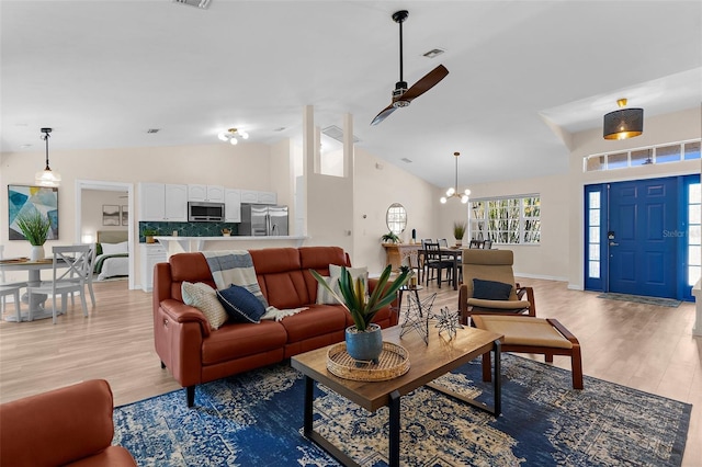 2424 Affinity Ln, North Port, FL 34286 - living area featuring ceiling fan, light wood-style floors, high vaulted ceiling, and a chandelier