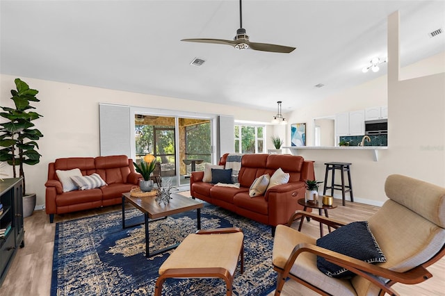 2424 Affinity Ln, North Port, FL 34286 - living area with light wood-style flooring, lofted ceiling, a ceiling fan, and baseboards
