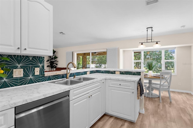 2424 Affinity Ln, North Port, FL 34286 - kitchen with dishwasher, a sink, decorative backsplash, light wood-style floors, and decorative light fixtures
