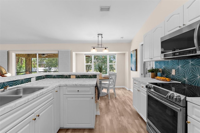 2424 Affinity Ln, North Port, FL 34286 - kitchen with appliances with stainless steel finishes, decorative backsplash, and white cabinets