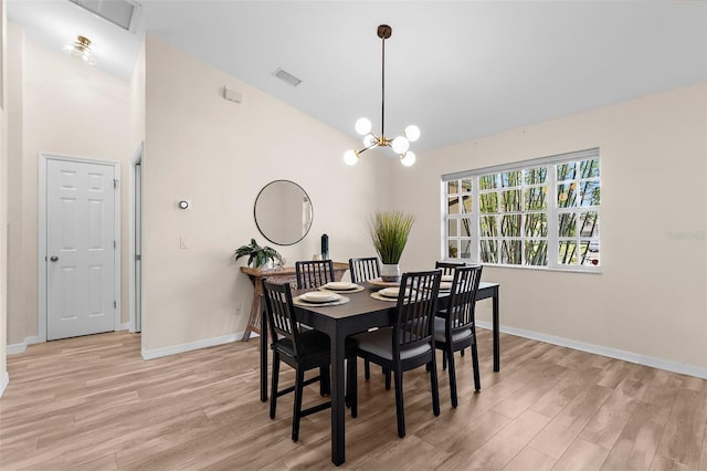 2424 Affinity Ln, North Port, FL 34286 - dining room with light wood-style flooring, baseboards, a chandelier, and vaulted ceiling