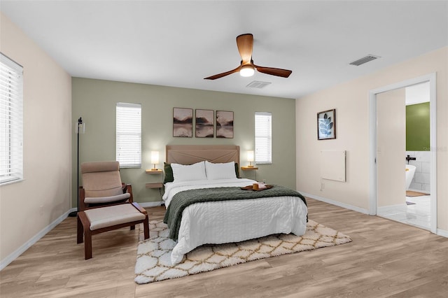 2424 Affinity Ln, North Port, FL 34286 - bedroom featuring light wood-style floors, multiple windows, and baseboards