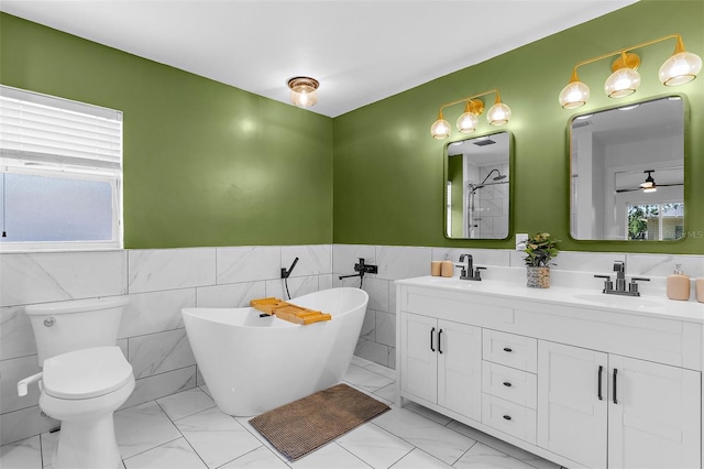 2424 Affinity Ln, North Port, FL 34286 - full bathroom with plenty of natural light, tile walls, marble look tile flooring, a freestanding bath, and double vanity