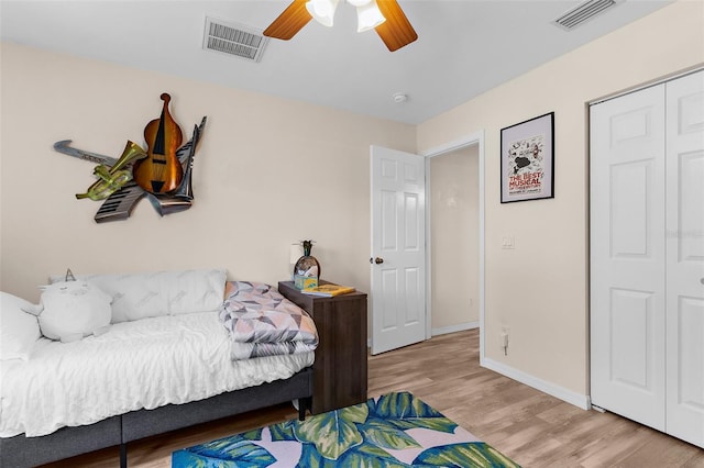 2424 Affinity Ln, North Port, FL 34286 - bedroom with light wood finished floors, a closet, a ceiling fan, and baseboards