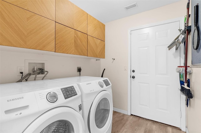 2424 Affinity Ln, North Port, FL 34286 - washroom with cabinet space, washer and clothes dryer, light wood finished floors, and baseboards