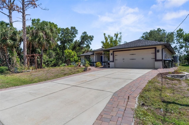 2424 Affinity Ln, North Port, FL 34286 - ranch-style home featuring a garage, concrete driveway, stucco siding, and a front yard