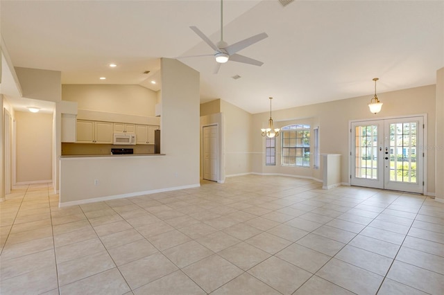 3851 Sterling Rd, Venice, FL 34293 - unfurnished living room featuring french doors, light tile patterned flooring, a ceiling fan, a chandelier, and high vaulted ceiling