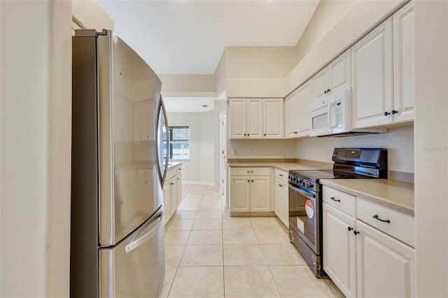 3851 Sterling Rd, Venice, FL 34293 - kitchen with appliances with stainless steel finishes, light tile patterned floors, white cabinetry, and light countertops