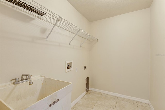 3851 Sterling Rd, Venice, FL 34293 - washroom with electric dryer hookup, hookup for a washing machine, light tile patterned floors, and baseboards